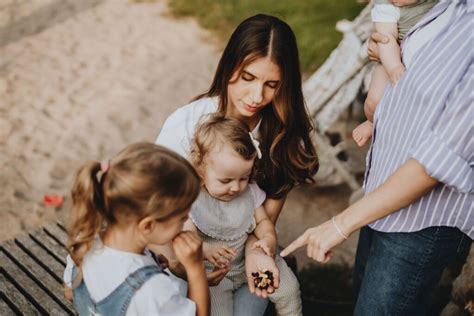 Šeima su vaiku, naudojanti kelioninę lovytę lauke