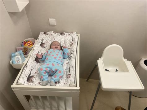 Vaikas vystymo stalo vietoje su žaislais